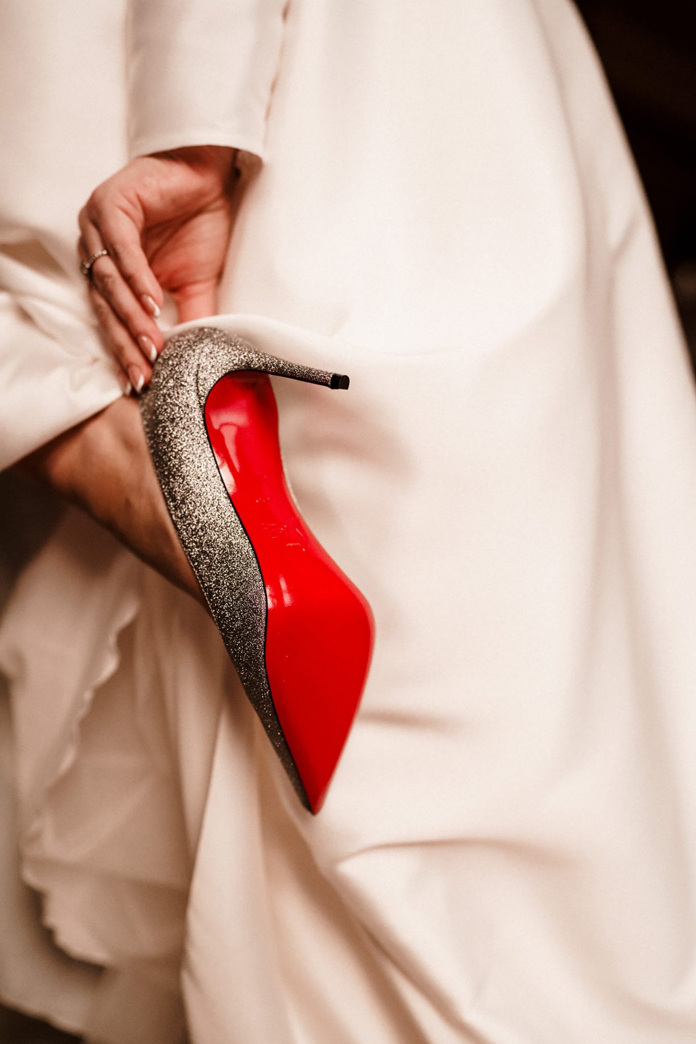 bride holding her wedding shoes