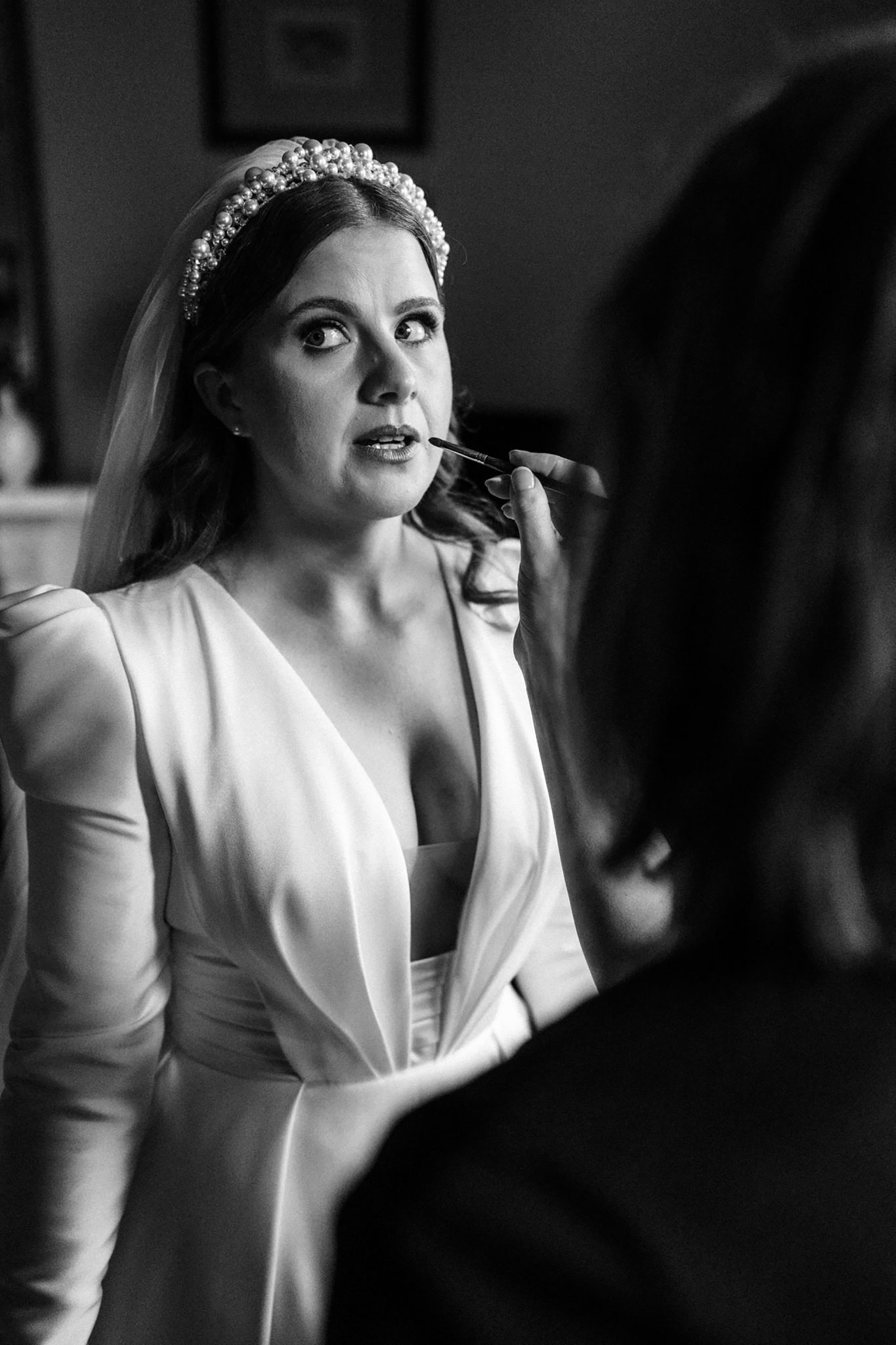 wedding photography being taken of bride having make up