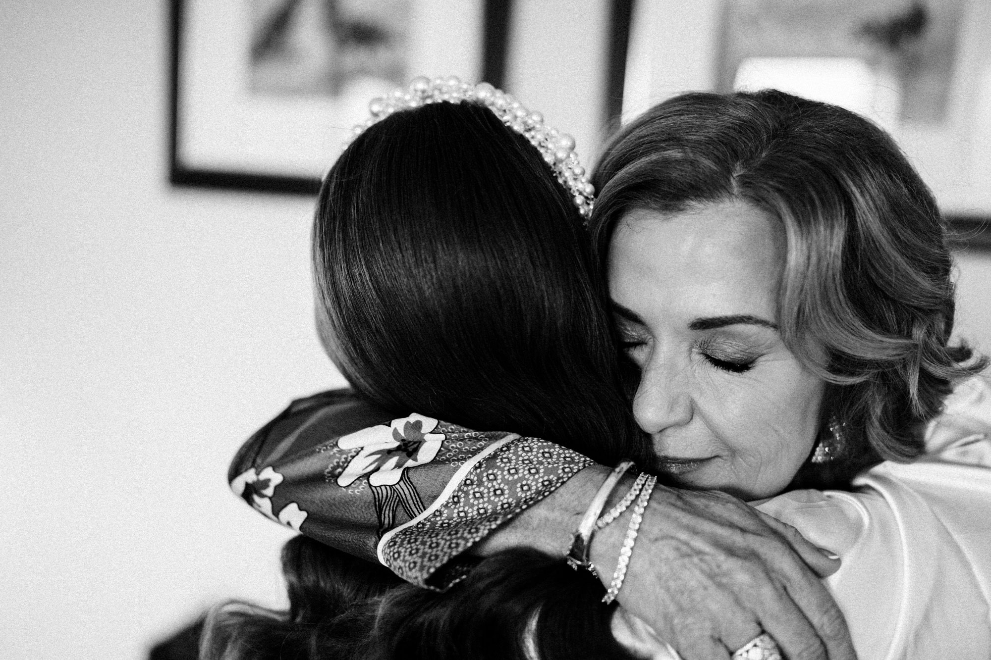 candid wedding moment between a mother of the bride and her daughter.